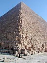 corner of second pyramid * The corner view of the pyramid of Chephren. The construction is clearly visible with the huge volume of blocks.  Notice the person standing in the foreground to give an idea of the size. * 324 x 432 * (65KB)