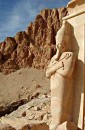 statue and crags deir el bahir * Statue in temple, profiled against the crags above. * 285 x 432 * (46KB)