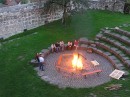 firepit from above * Helmut is just getting the fire started, using numerous wood pallets. Some people are sitting around, obviuosly not yet needing the warmth of the flames. * 432 x 323 * (59KB)
