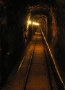 tunnel with tracks * One of the many tunnels we wandered down while on the tour of this iron mine.  In the late 1800s this mine was the major industry of the area. * 314 x 432 * (42KB)