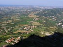 View with shadow of towers * A view of the countryside to the sea from San Marino.  The shadow highlights the shape of the mountain top and the first tower (left) and second tower (right). * 432 x 323 * (59KB)